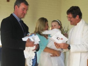 Padre Dave Jackson at a baptism